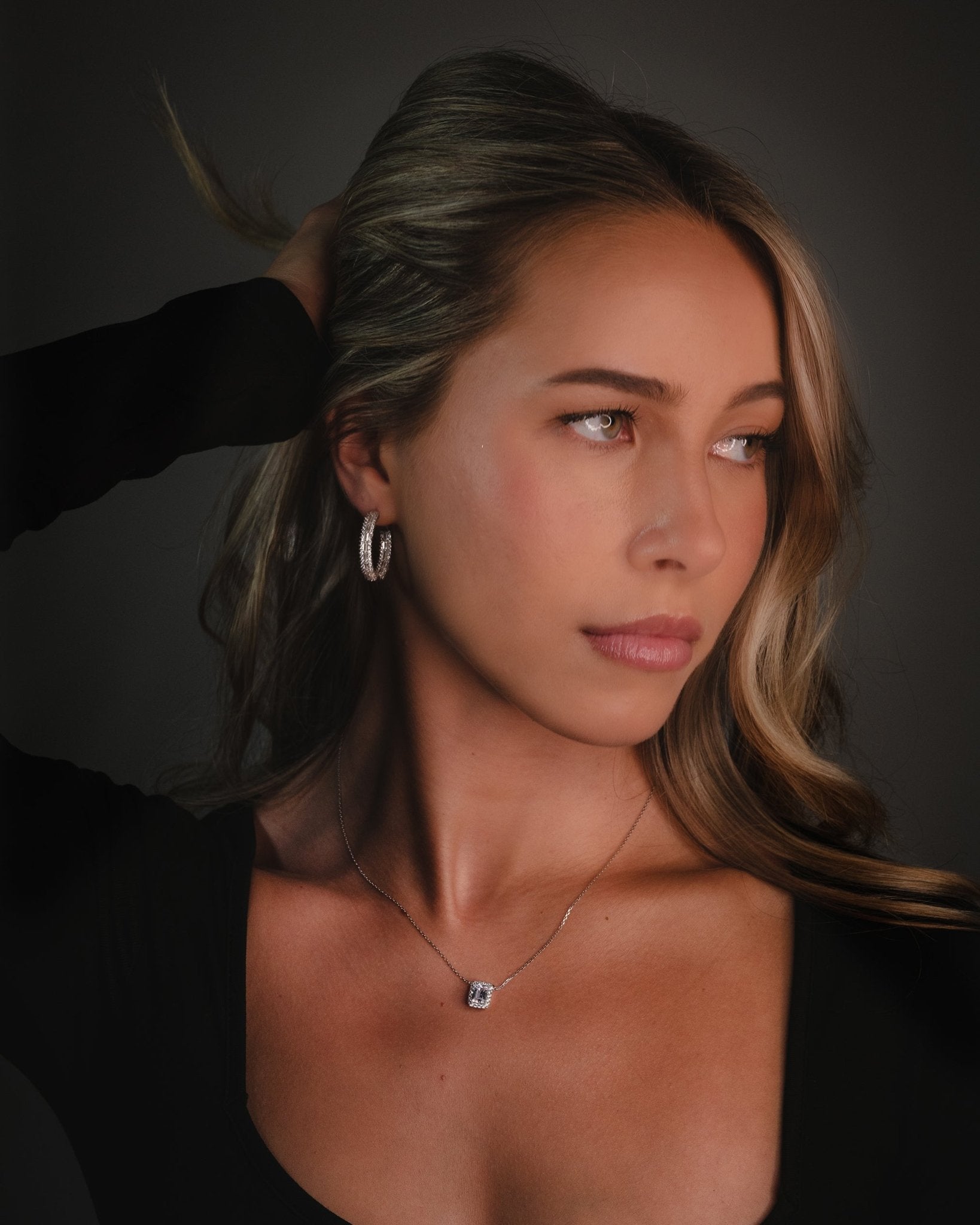 Marzi Huggie Hoop Earrings with emerald and round cut simulated diamonds set in polished sterling silver