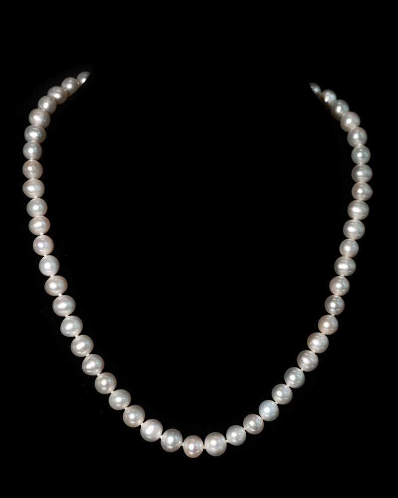 Maude Necklace featuring graduated 7–8 mm white freshwater pearls with sterling silver fish hook clasp