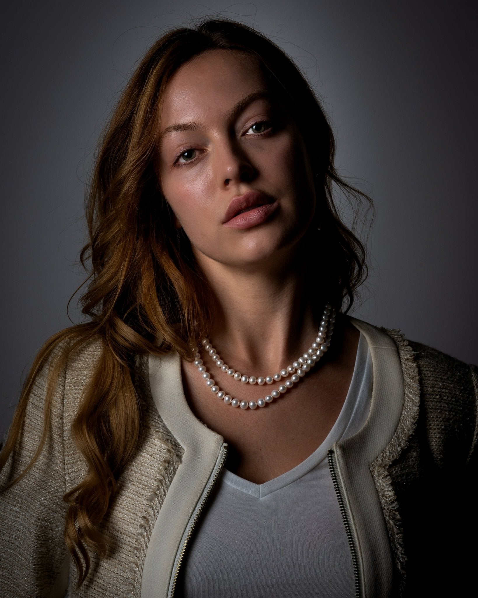 Maude Necklace featuring graduated 7–8 mm white freshwater pearls with sterling silver fish hook clasp