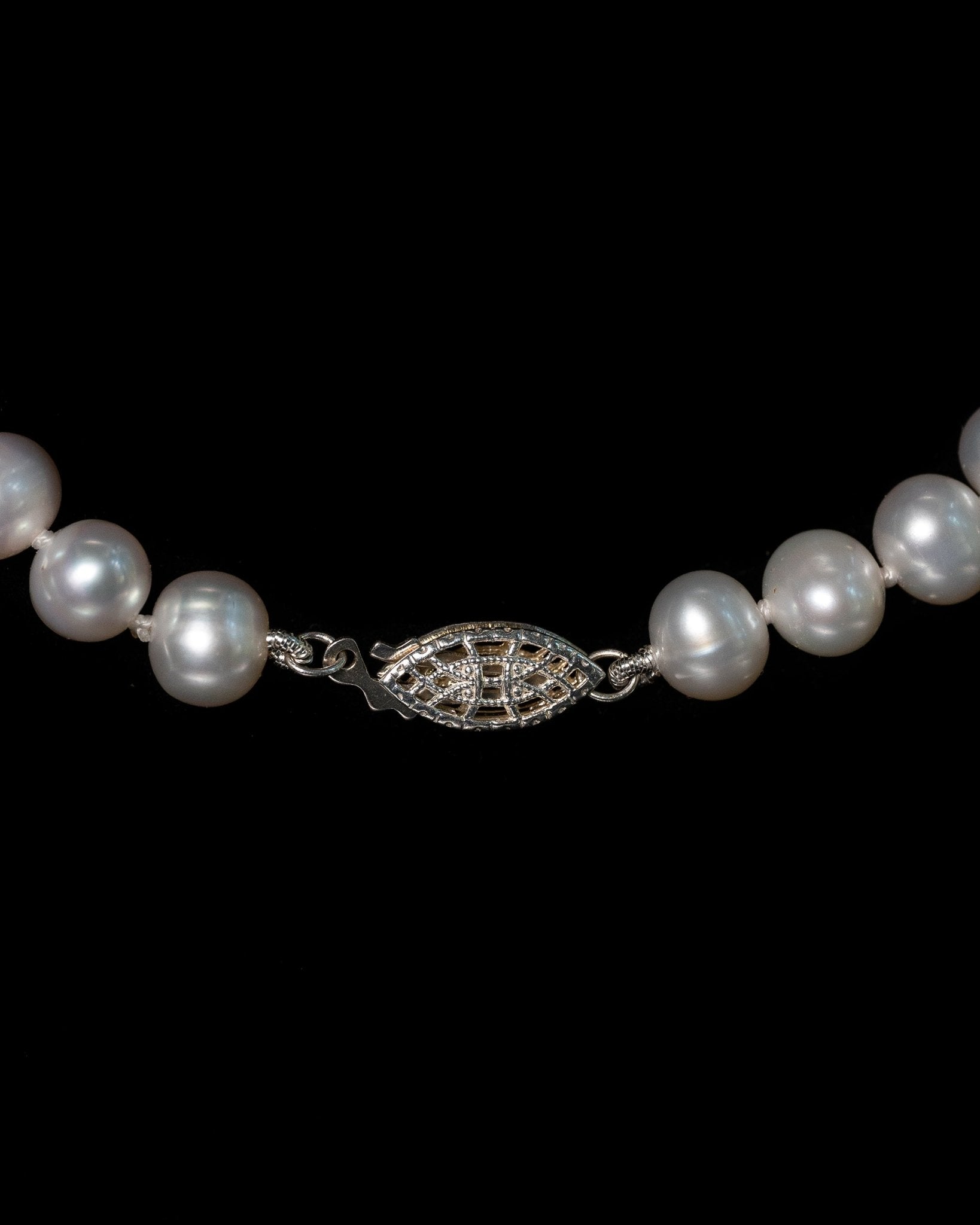 Maude Necklace featuring graduated 7–8 mm white freshwater pearls with sterling silver fish hook clasp