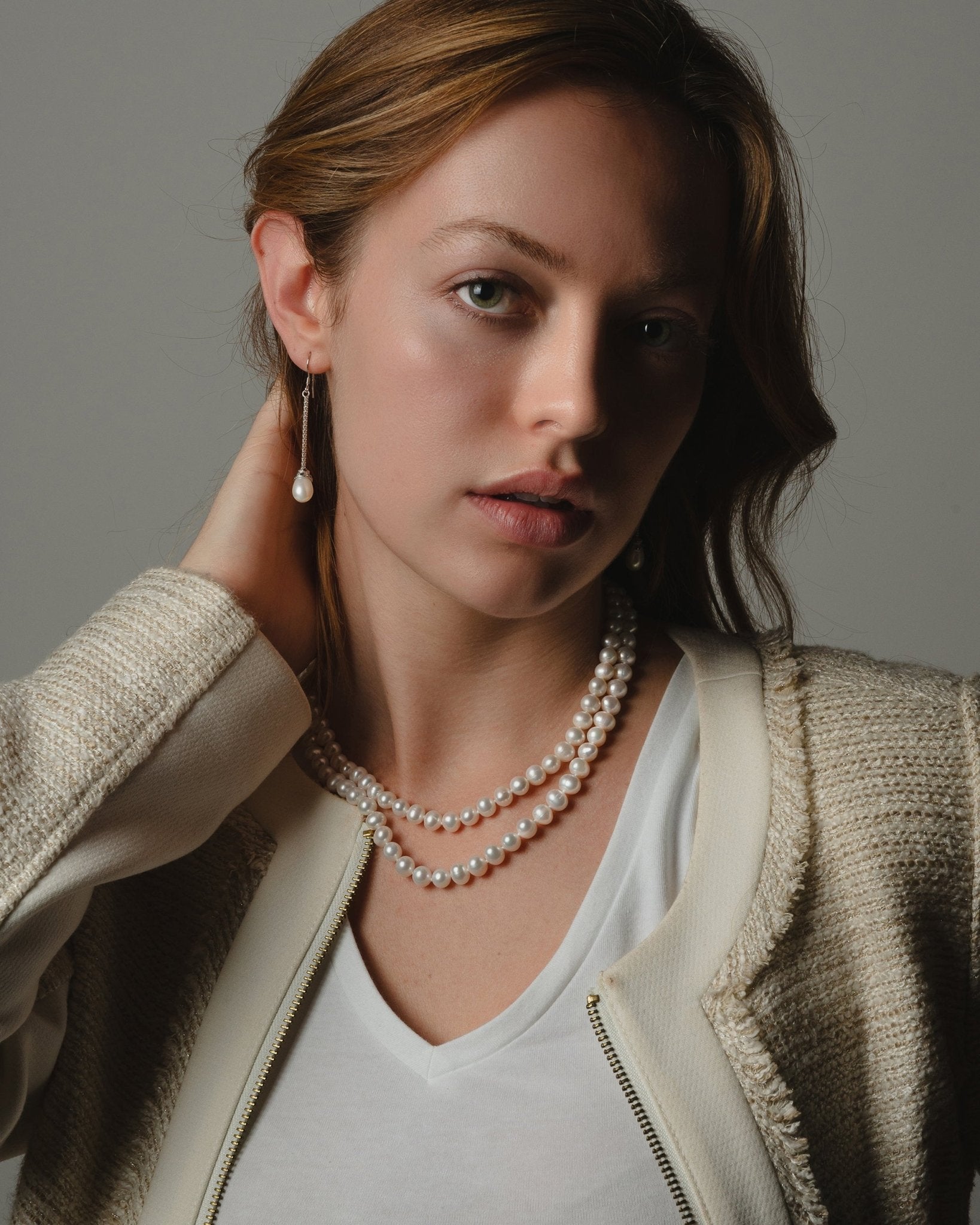 Maude Necklace featuring graduated 7–8 mm white freshwater pearls with sterling silver fish hook clasp
