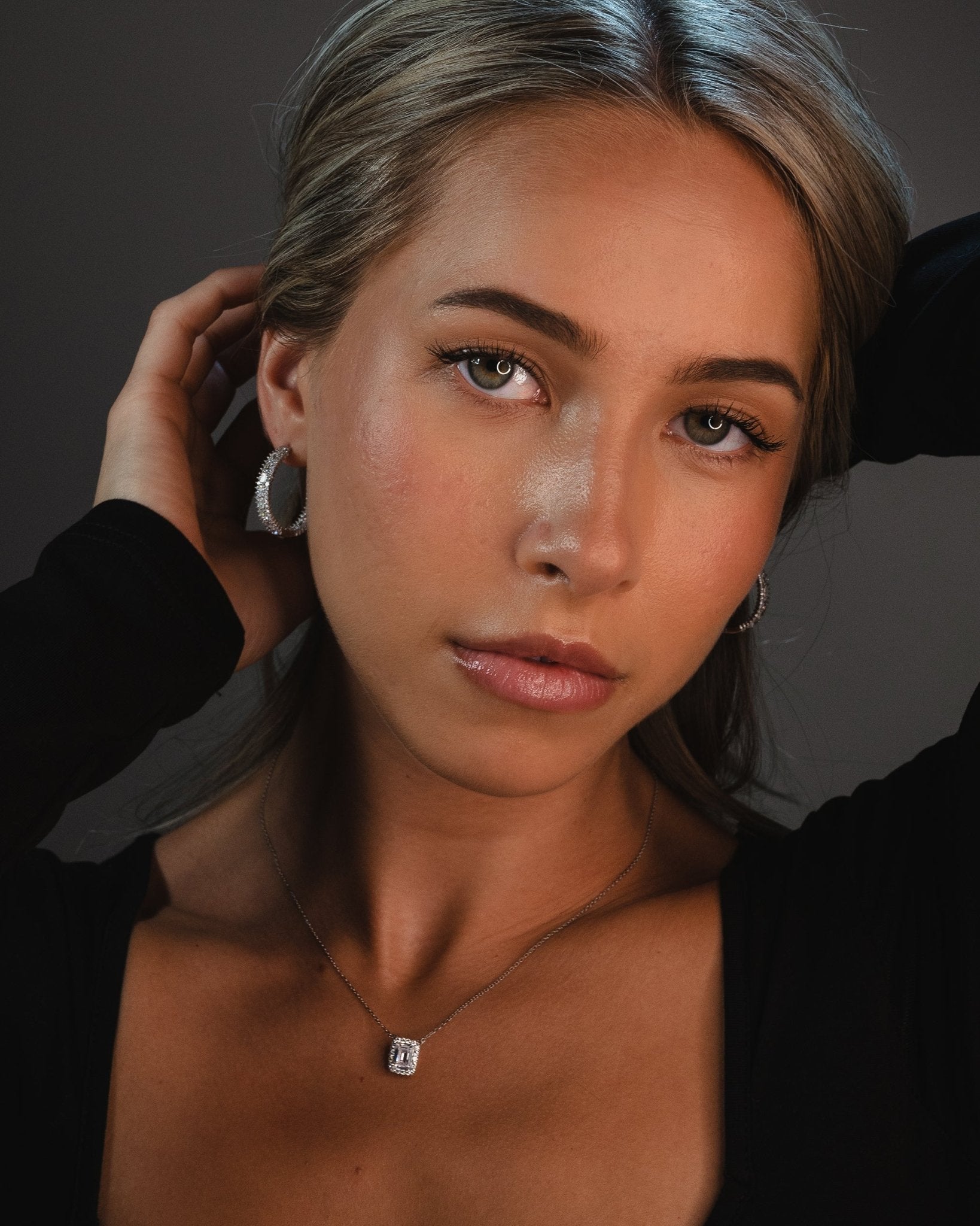 Marzi Huggie Hoop Earrings with emerald and round cut simulated diamonds set in polished sterling silver